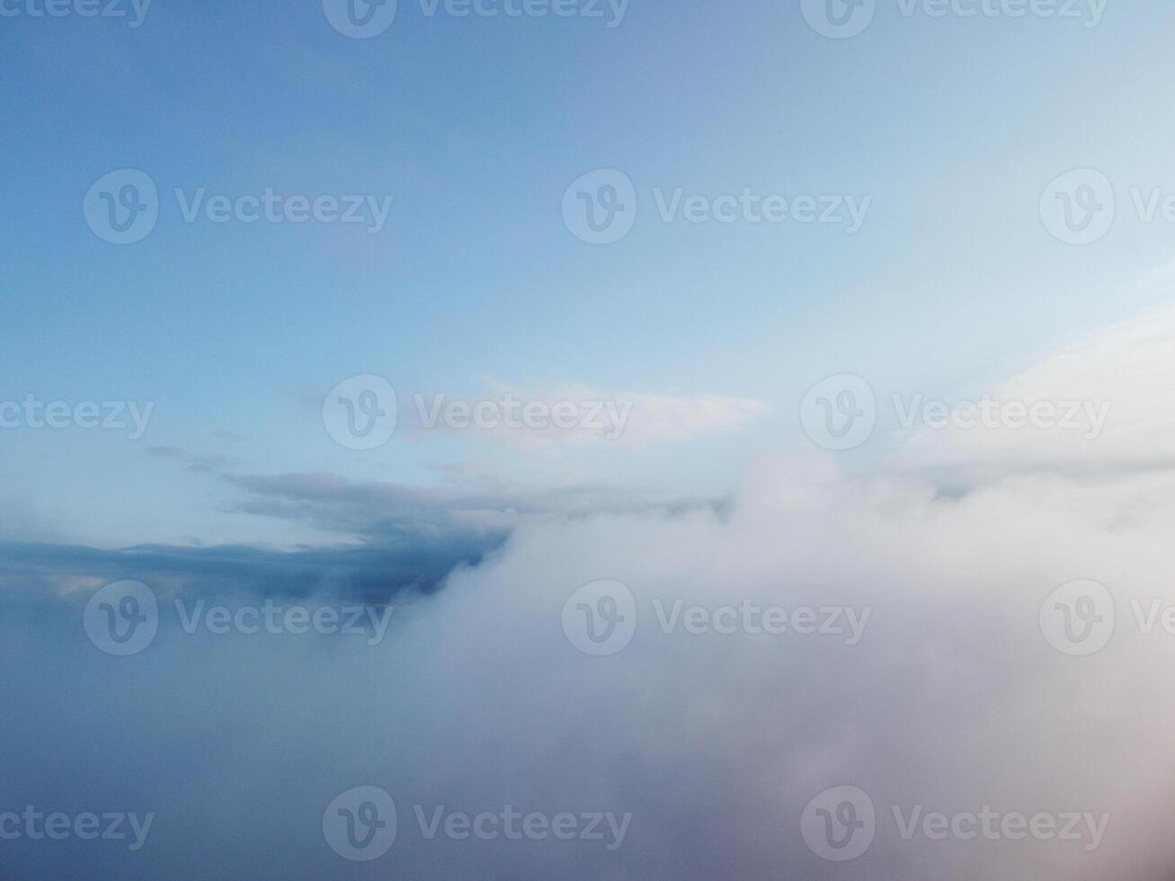Aerial view. Blue sky sun and fog over calm sea. The drone flies over foggy and fluffy clouds. Abstract aerial nature summer ocean sunset sea and sky background. Vacation, travel and holiday concept. photo