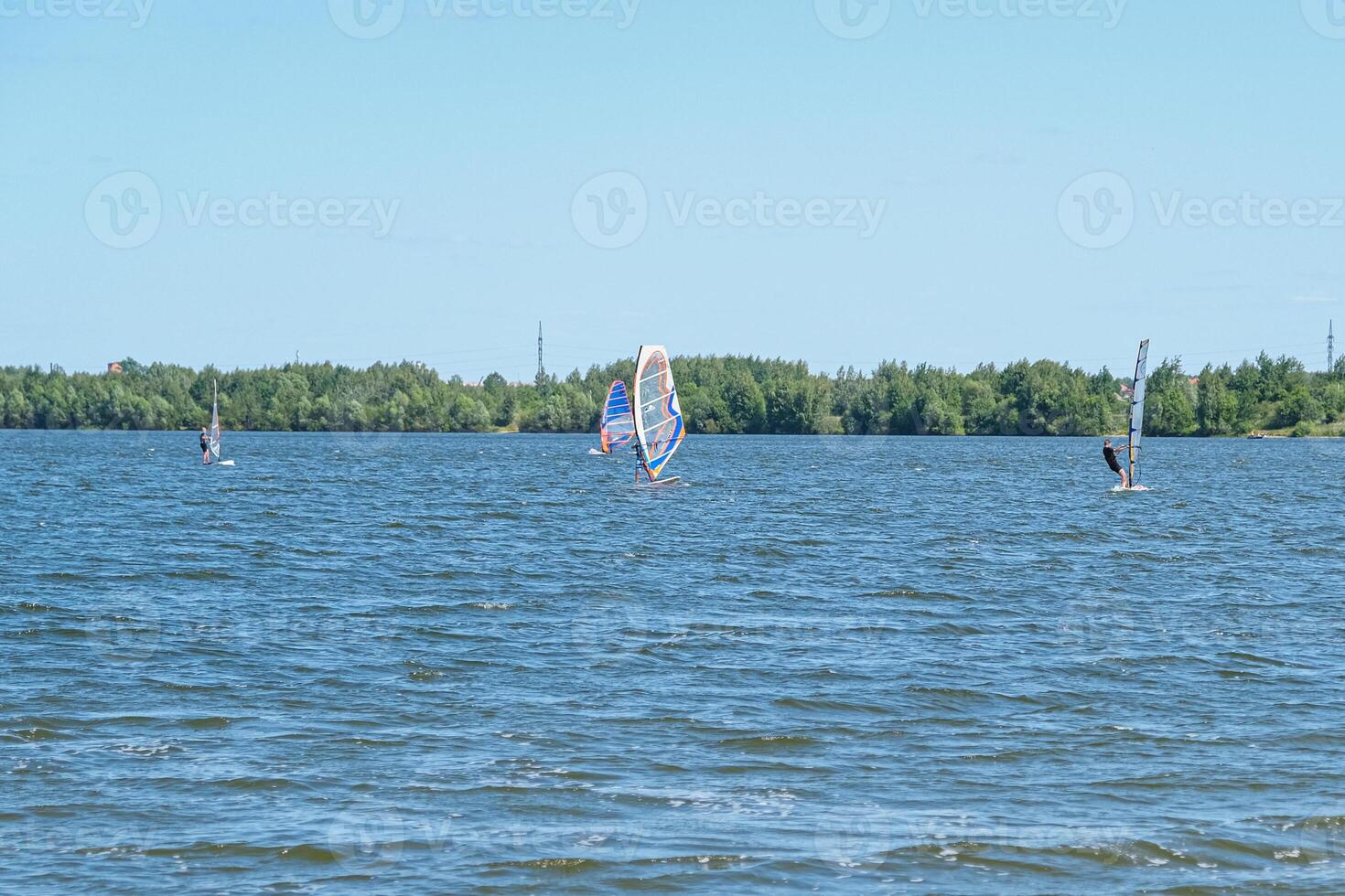 People doing kitesurfing and windsurfing photo