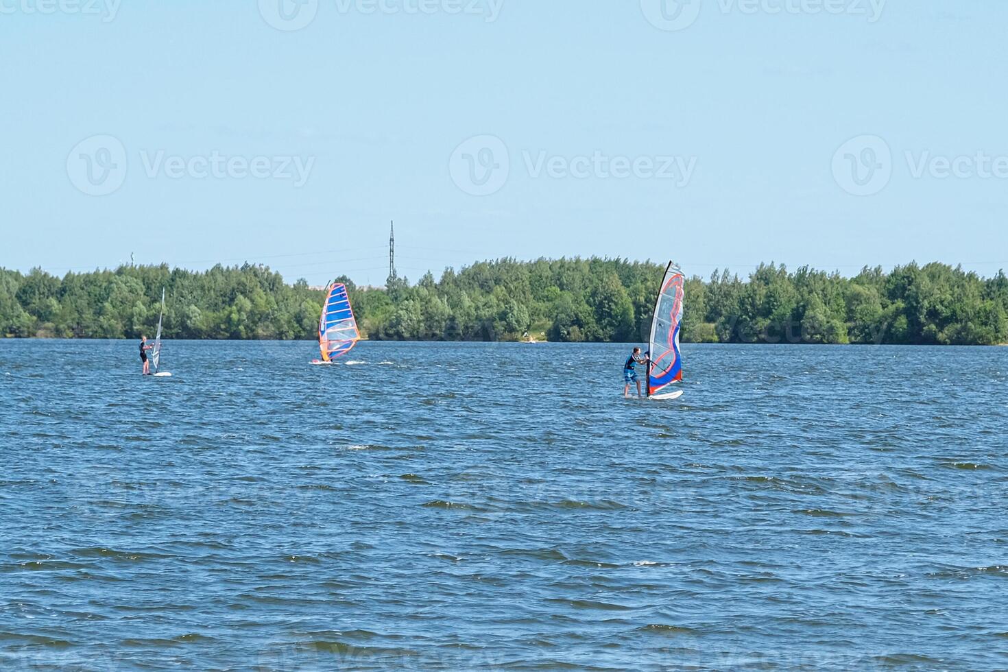 People doing kitesurfing and windsurfing photo
