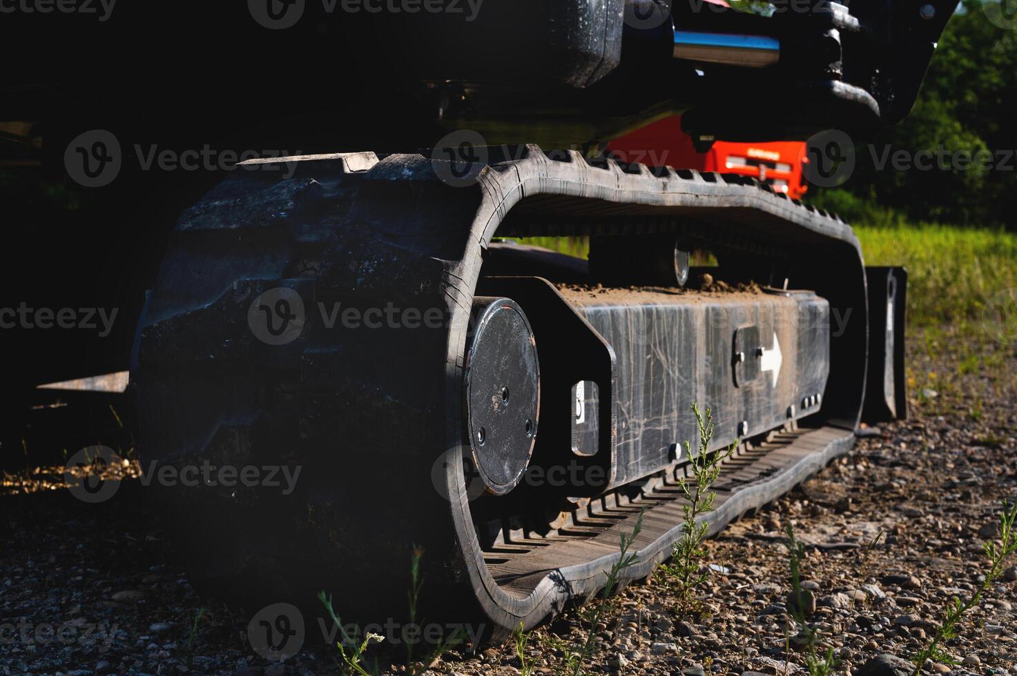 Rubber track shoes of a small excavator close-up photo