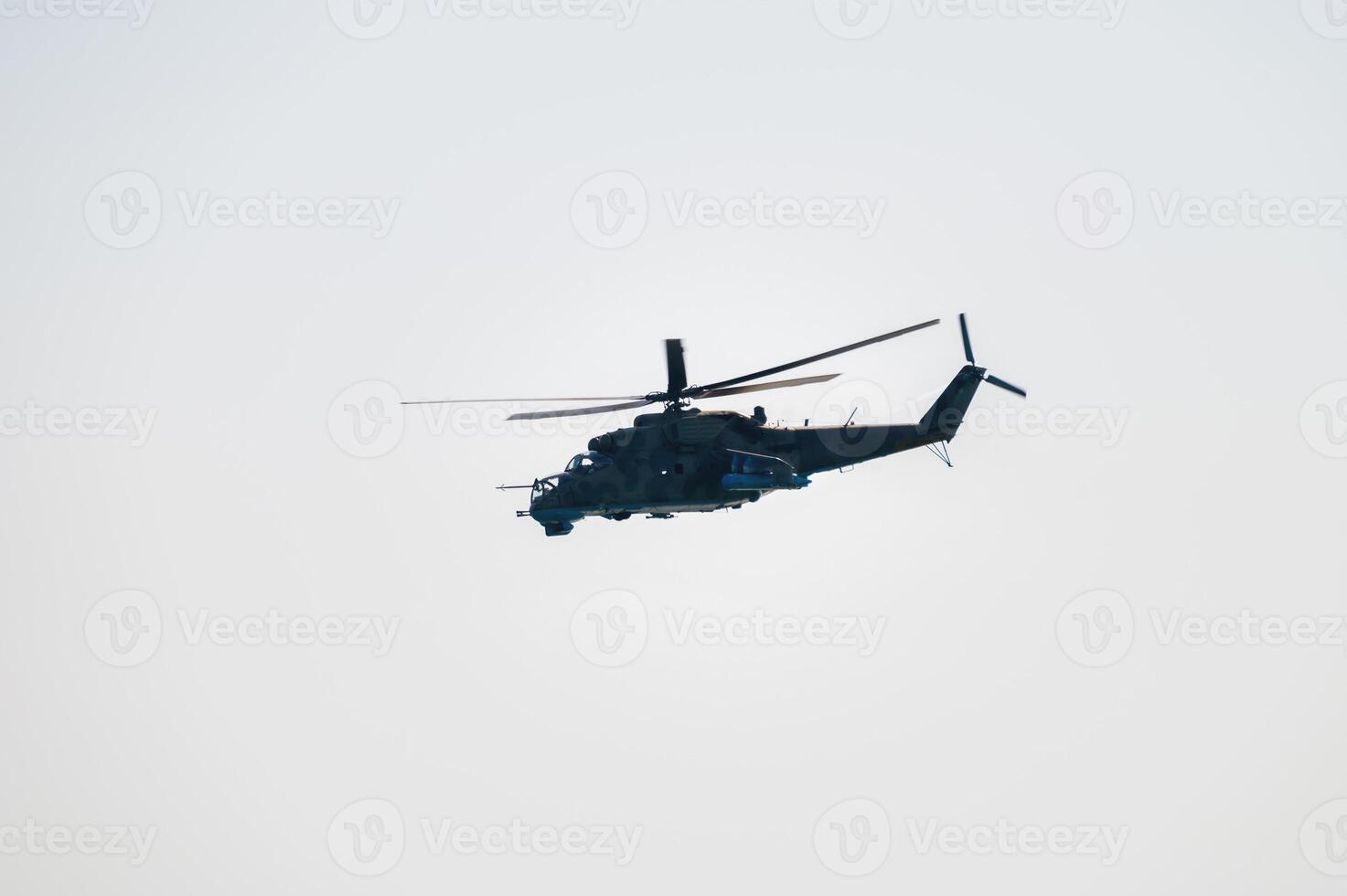 Military helicopter in clear skies. Unmarked helicopter photo