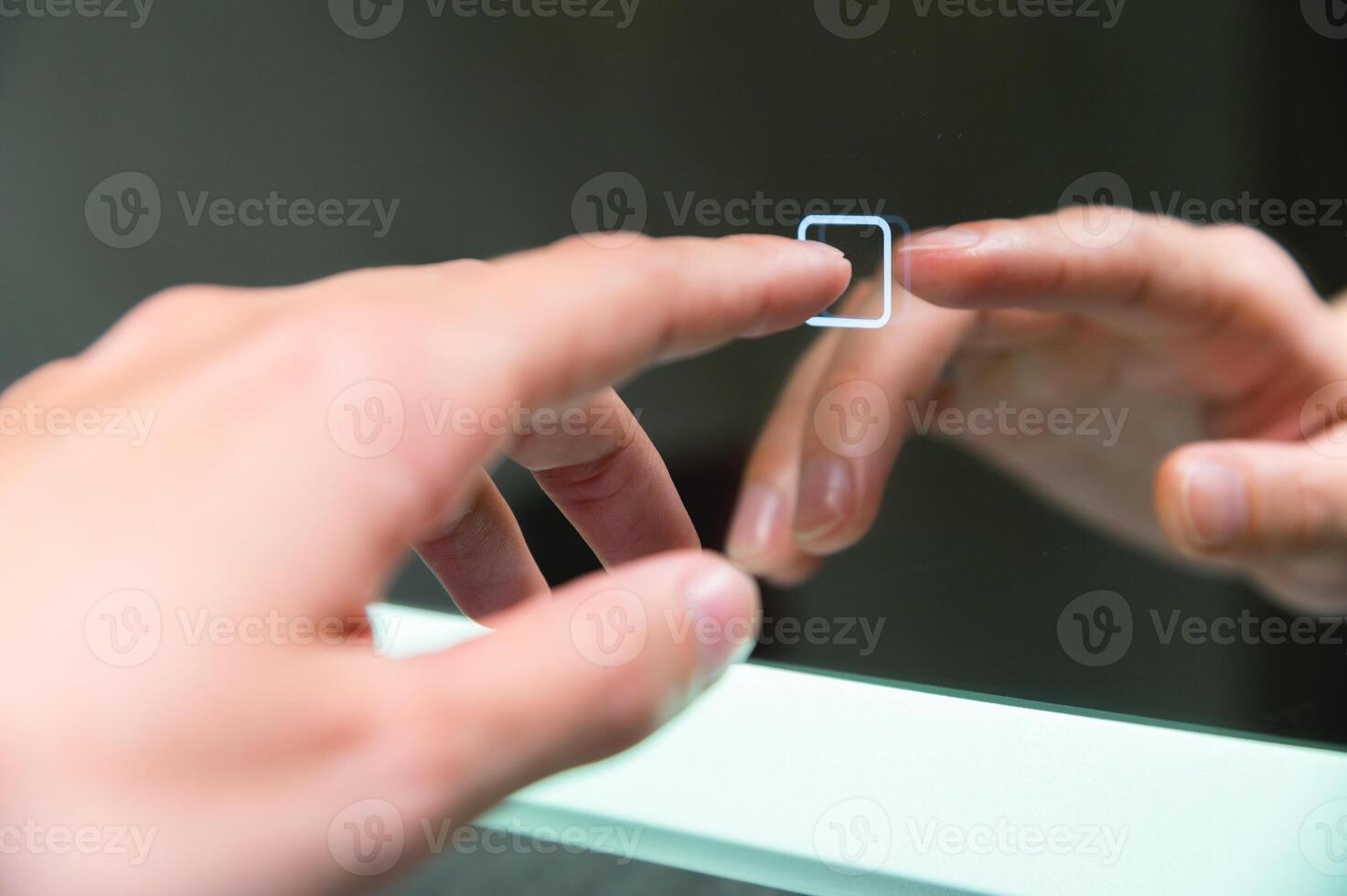 Woman's hand turns on the illumination of the bathroom mirror by touching the touch button on and off. Modern technologies photo
