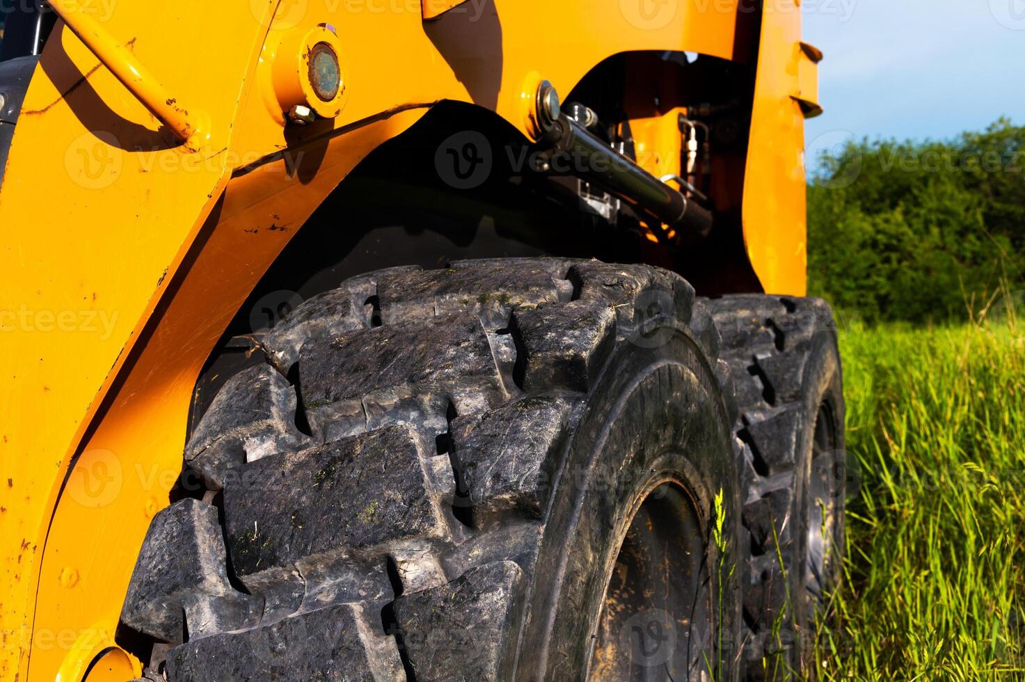 Close-up of a small backhoe loader wheel. Deep tread outdoors photo