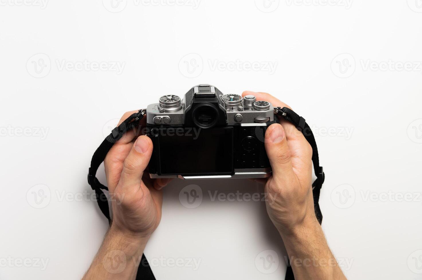 Digital SLR camera in retro style in male hands on a white background photo