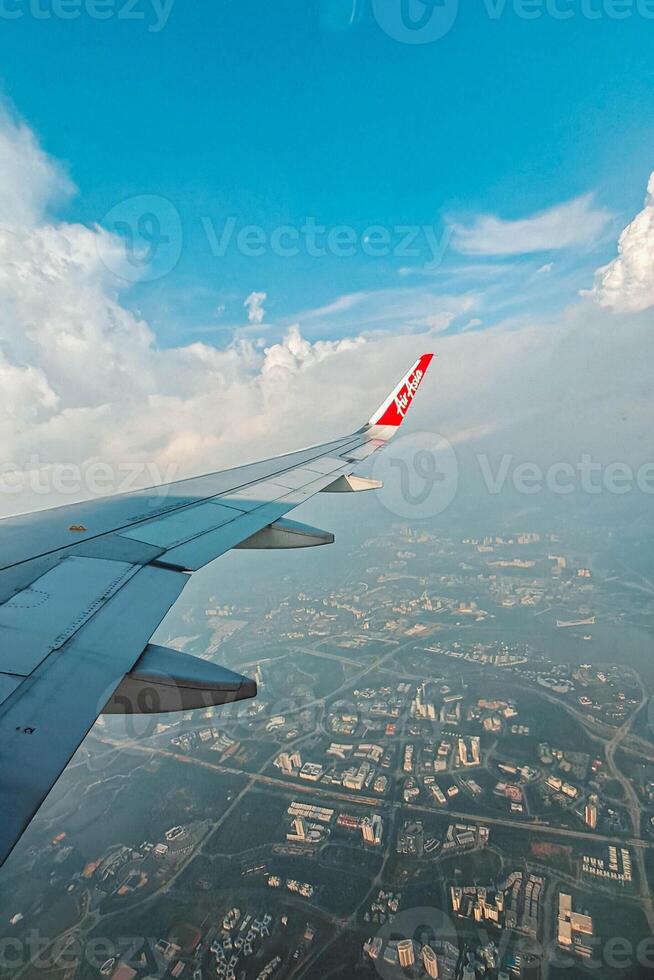 Footage of a clear, white cloudy sky from a commercial airplane window. The view from inside the plane is a daytime sky with white clouds moving smoothly photo