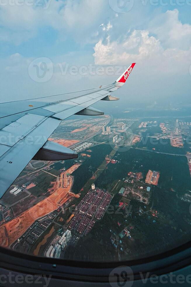 Footage of a clear, white cloudy sky from a commercial airplane window. The view from inside the plane is a daytime sky with white clouds moving smoothly photo