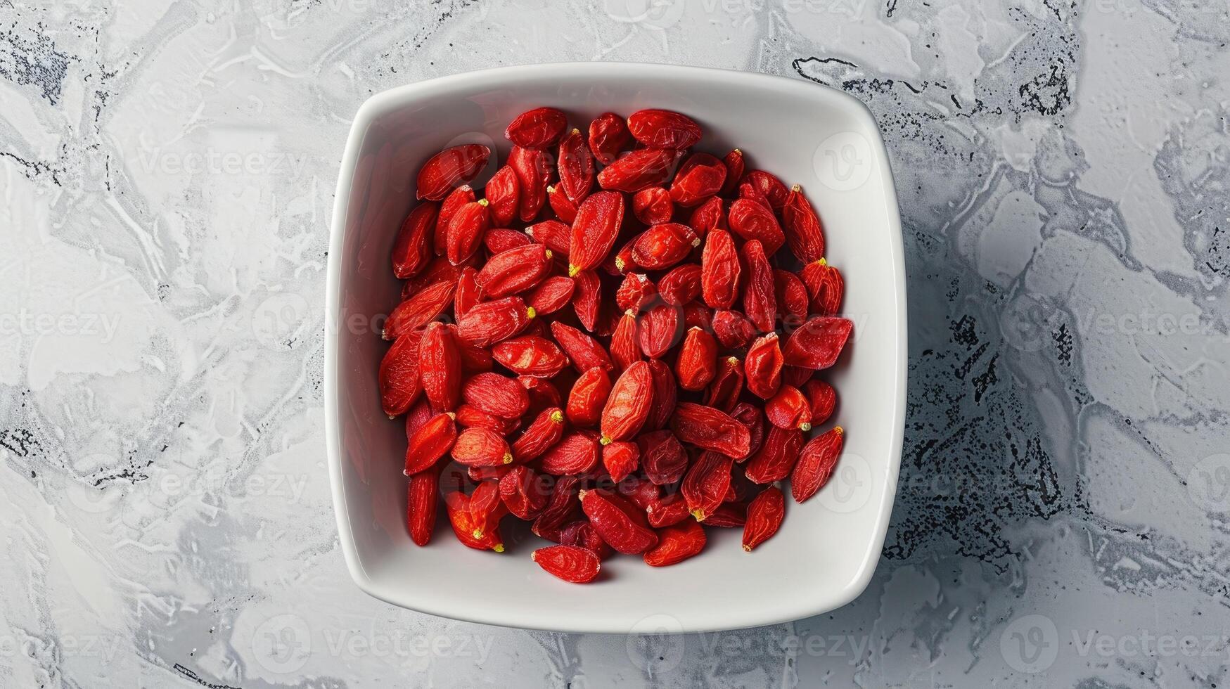 Bowl of dried goji berries emphasizing the vibrant red color and texture of the berries. photo