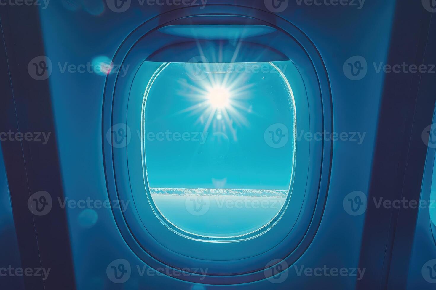 Sunlit airplane window view of sky and clouds scene. photo