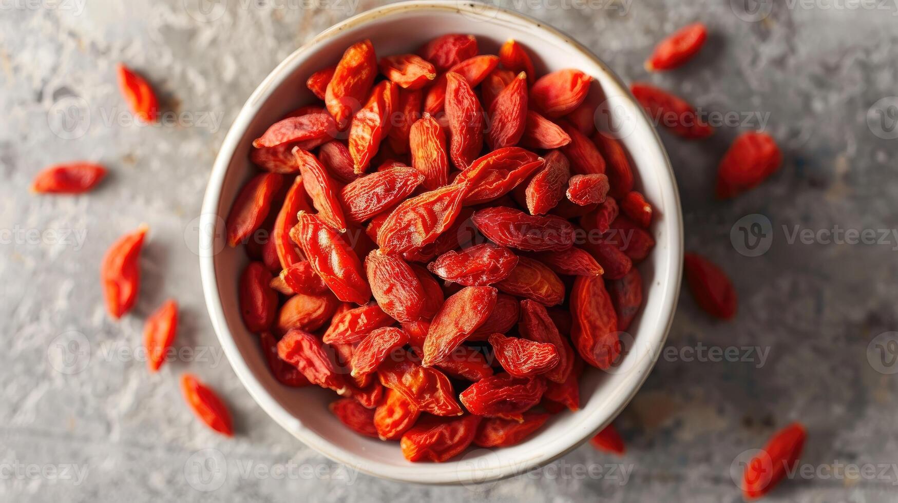 Bowl of dried goji berries emphasizing the vibrant red color and texture of the berries. photo