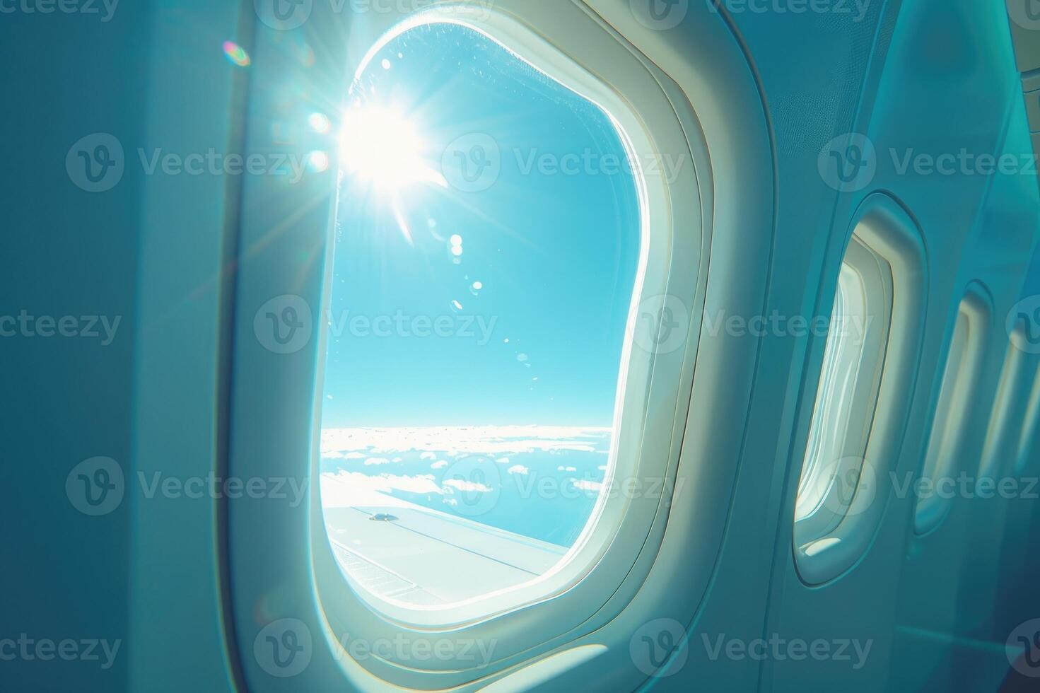 Sunlit airplane window view of sky and clouds scene. photo