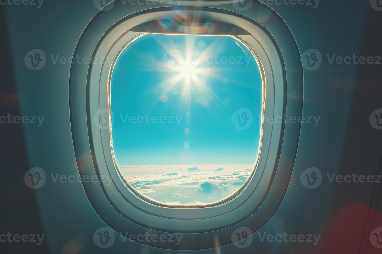 Sunlit airplane window view of sky and clouds scene. photo