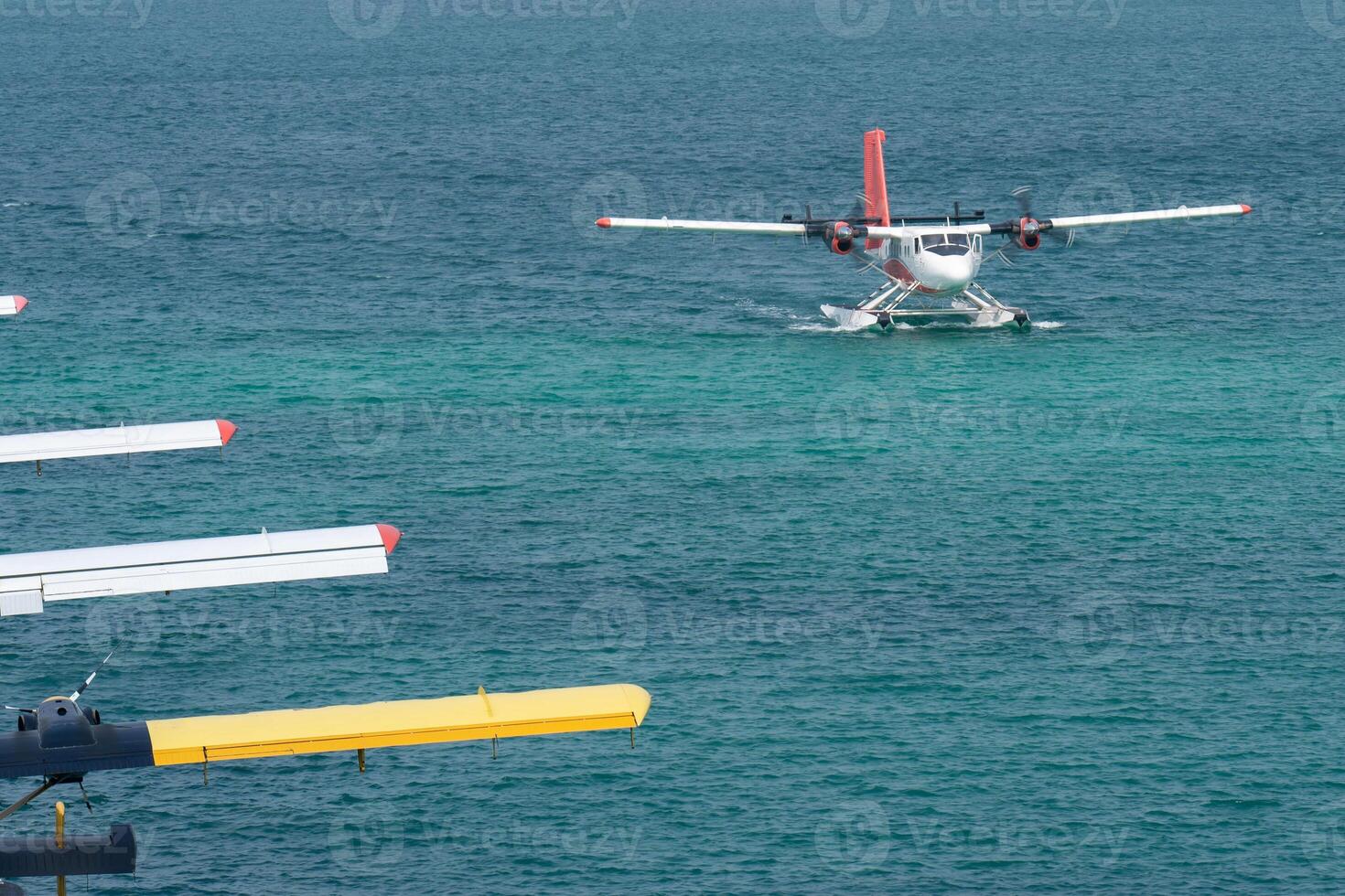 Seaplanes floating dock at Male airport, seaplanes in ocean lagoon. photo