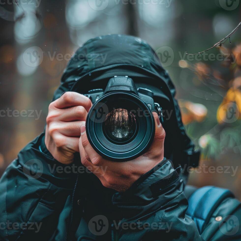 man hand holding camera looking through lens. photo