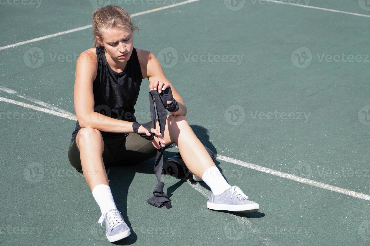 young female boxer training in the stadium photo