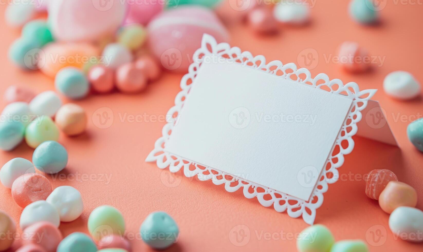 White blank card in a delicate lace frame on a pastel coral background photo