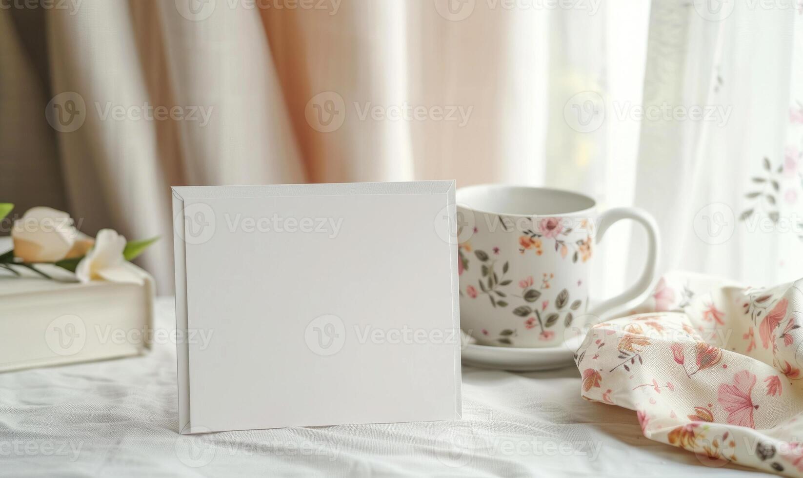 White blank card in a ceramic white frame on a pastel ivory table photo
