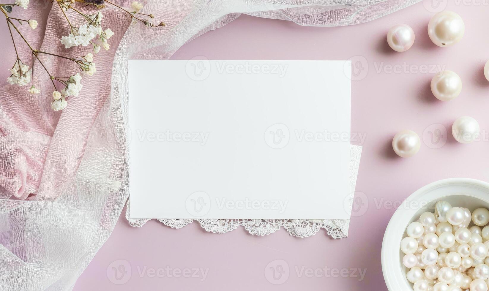 White blank card on a pastel lavender background, with a silk scarf and a pearl necklace photo