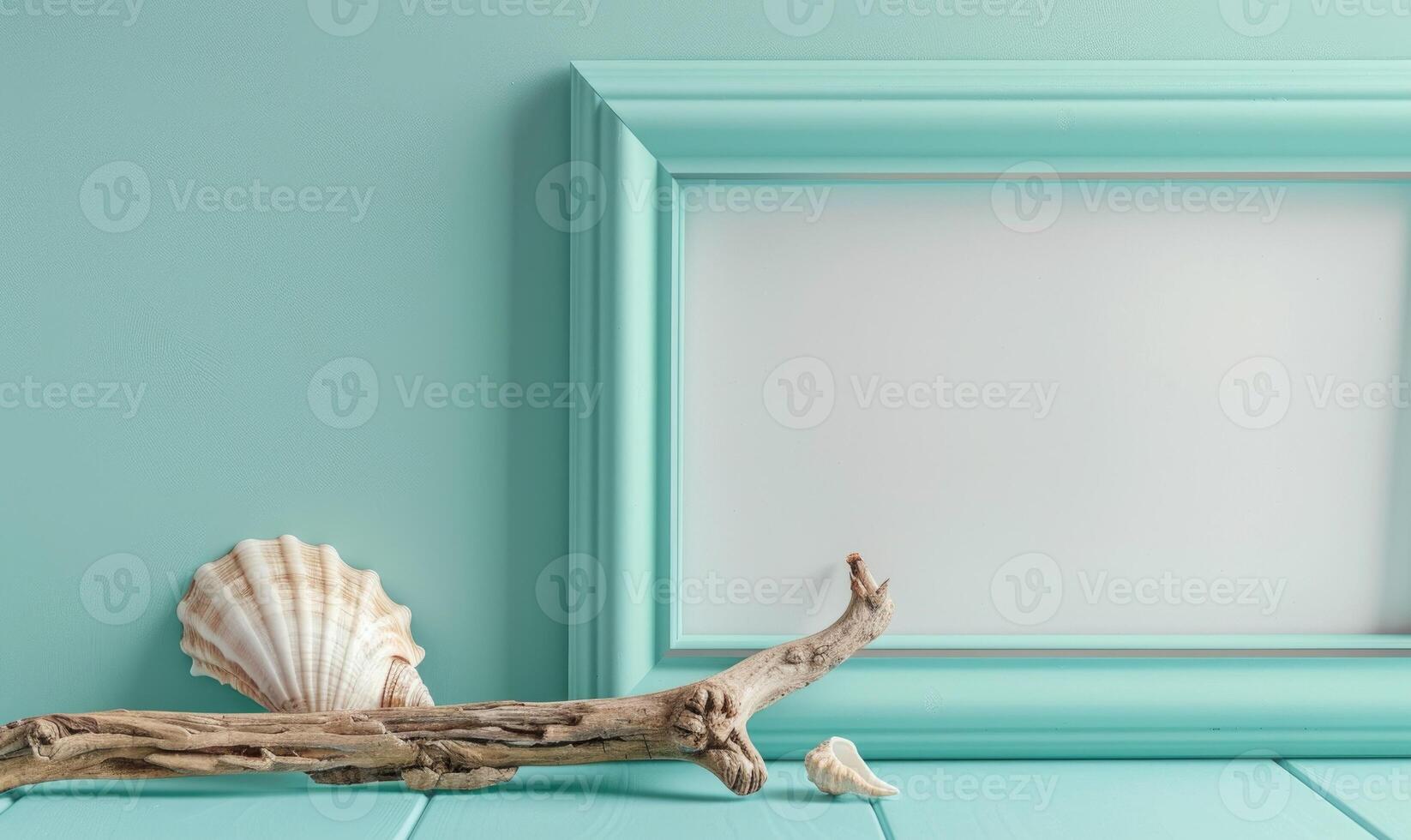 White blank card in a turquoise frame on a pastel turquoise background, with a seashell and a piece of driftwood photo
