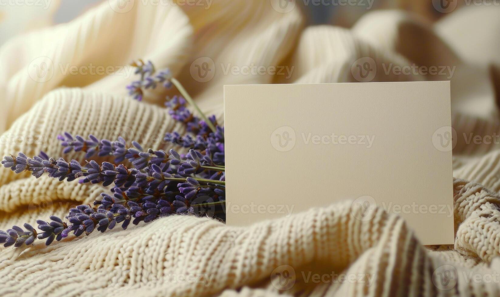 White blank card on a pastel butter yellow table, with a knitted cloth and a small lavender bunch photo