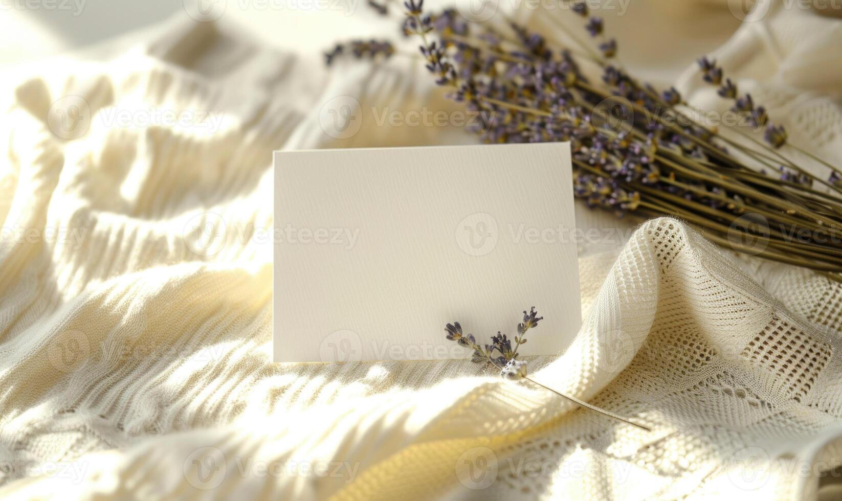 White blank card on a pastel butter yellow table, with a knitted cloth and a small lavender bunch photo