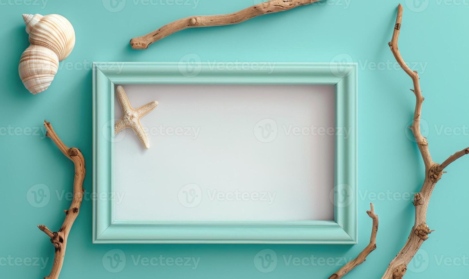 White blank card in a turquoise frame on a pastel turquoise background, with a seashell and a piece of driftwood photo