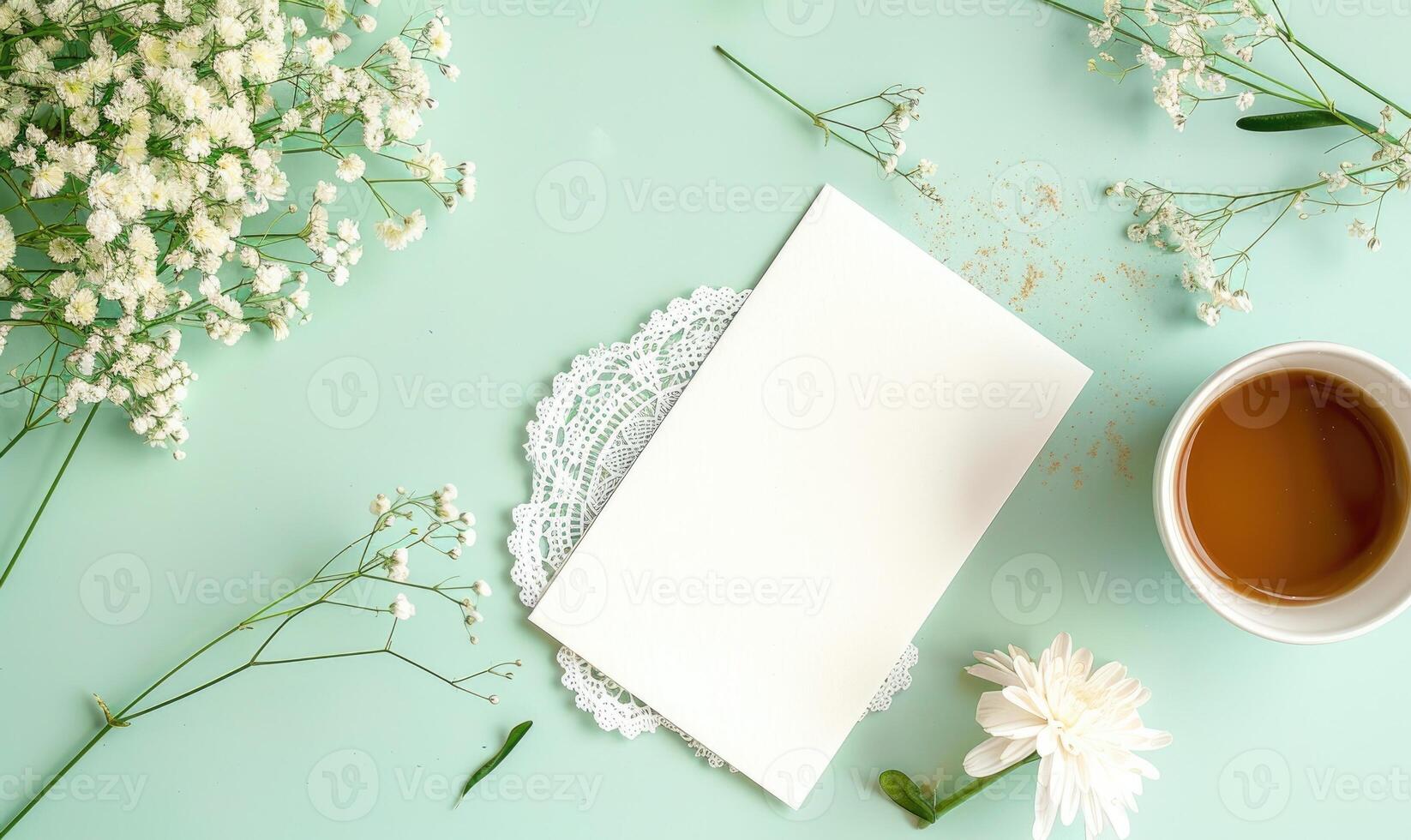 White blank card on a pastel green table, with a cup of coffee photo
