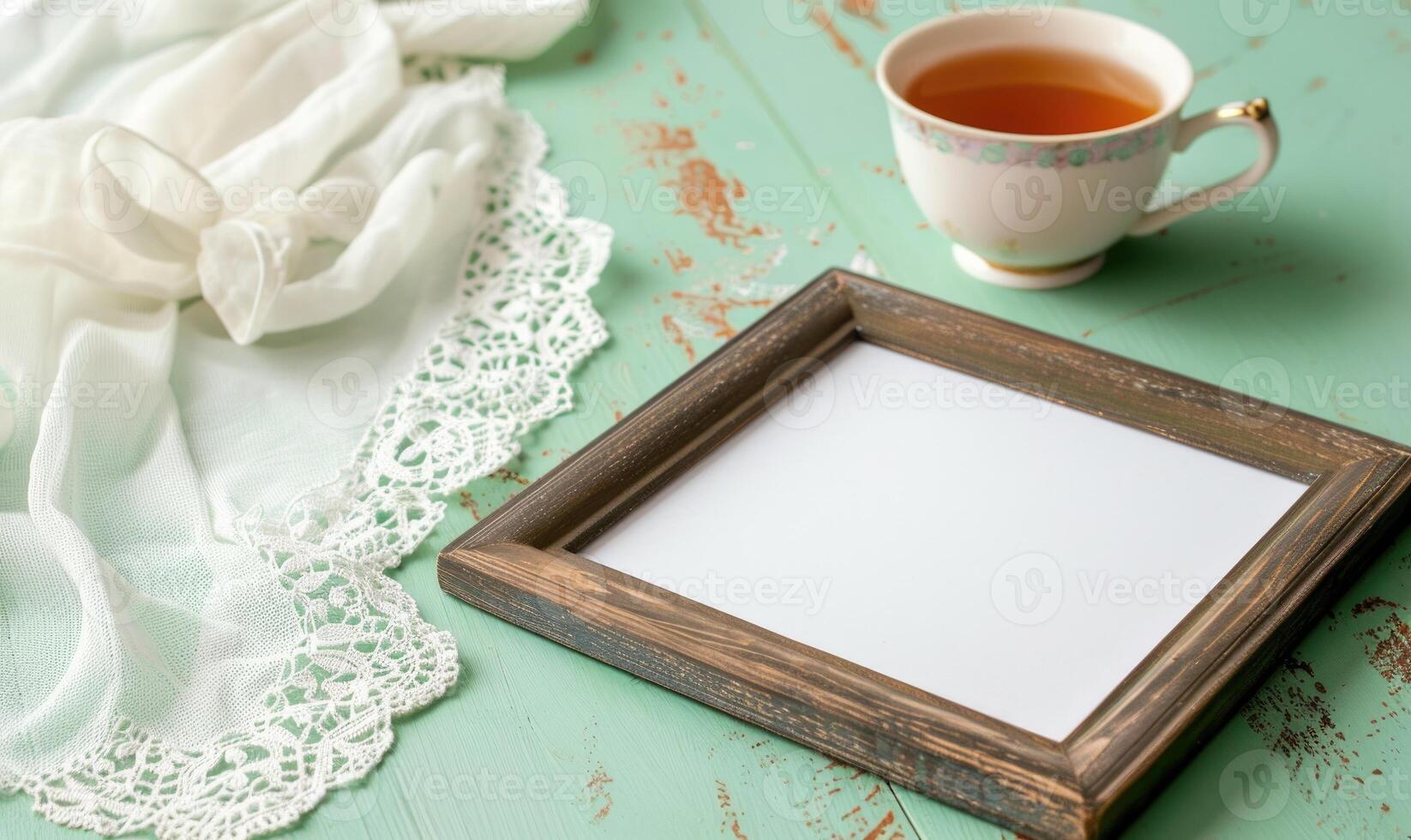 White blank card in a wooden frame on a pastel green table photo