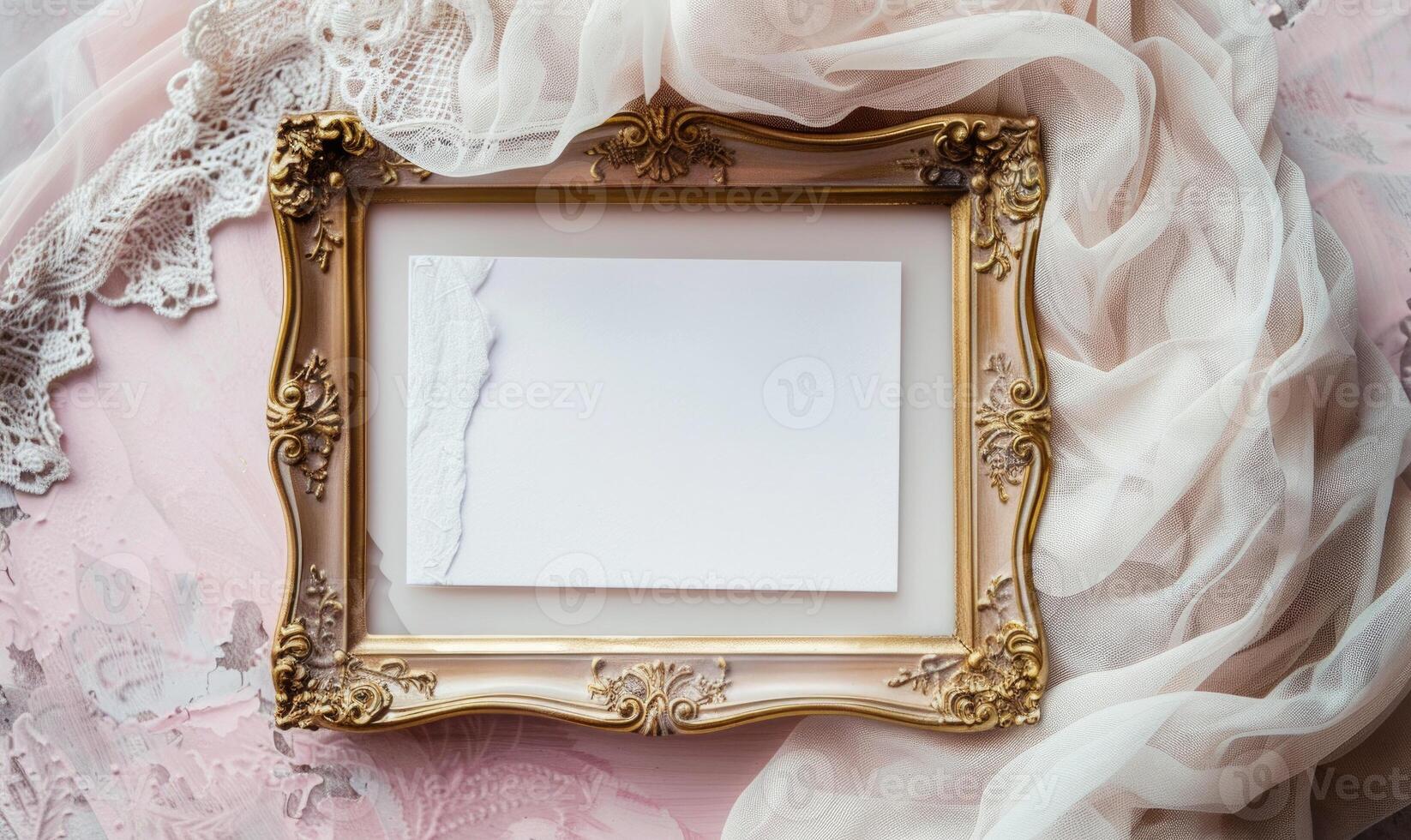 White blank card in an elegant gold frame on a pastel pink table, with a delicate lace cloth, soft lighting photo