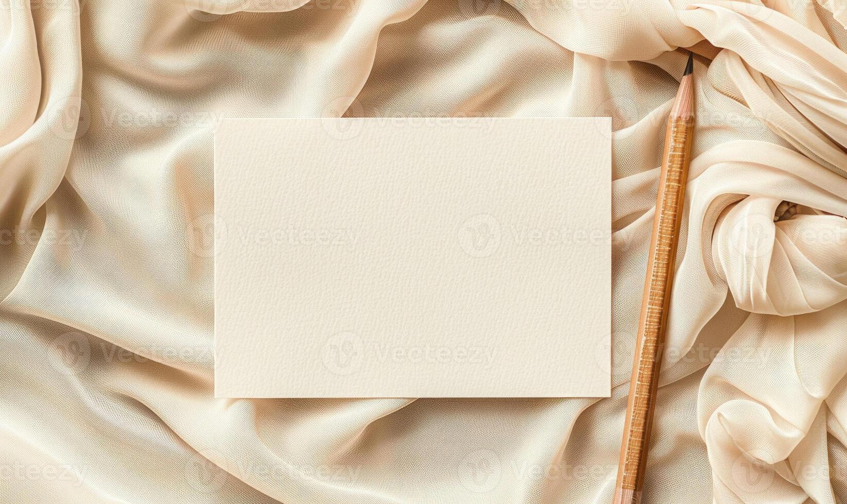 White blank card on a pastel cream background, with a piece of linen cloth and a handmade candle photo
