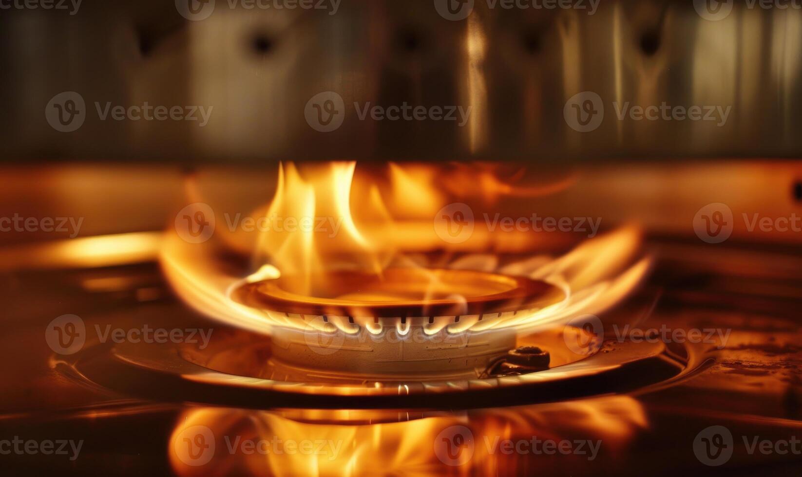 Extreme close-up of a gas cooktop burner emitting a steady flame photo