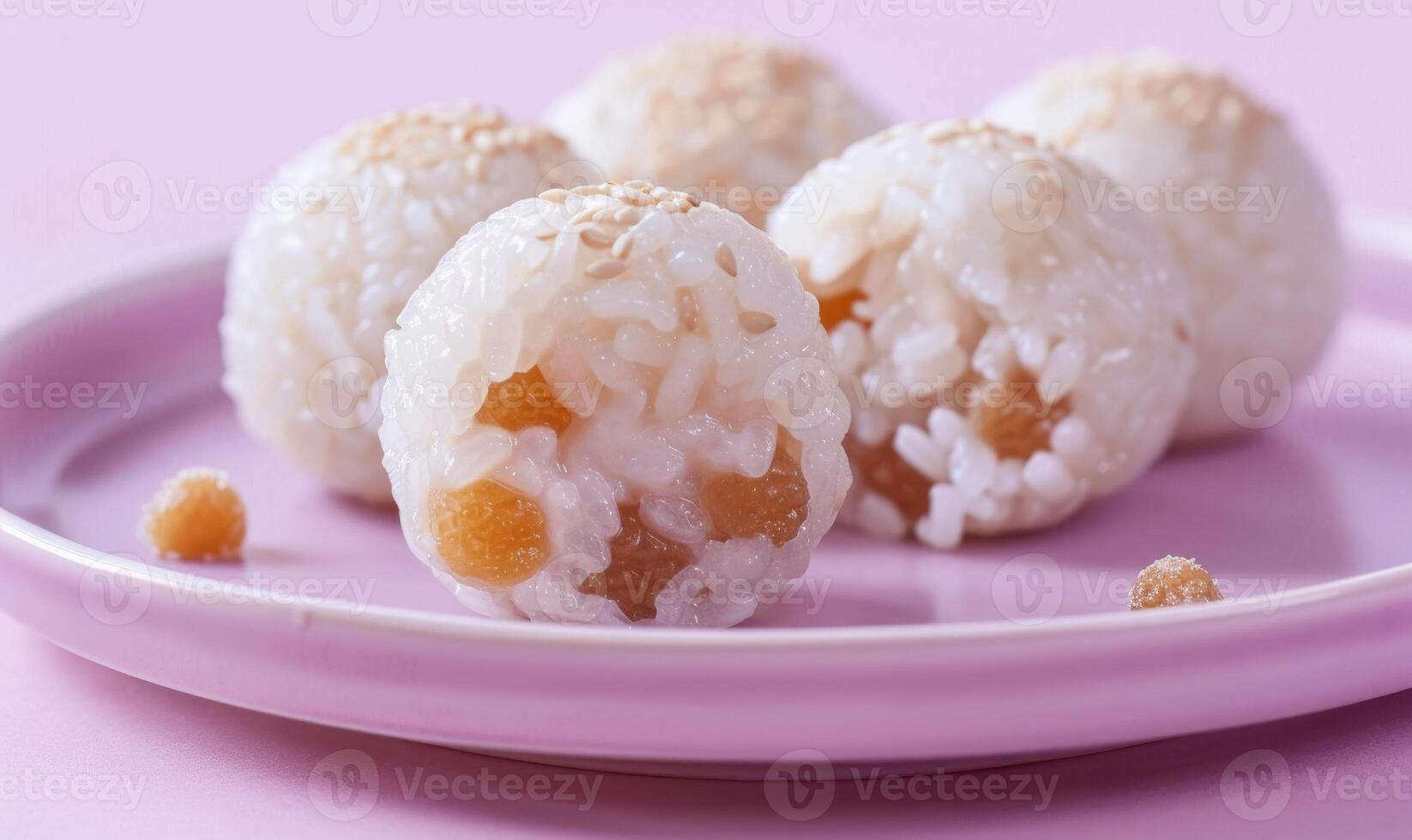 Chinese glutinous rice balls with sweet fillings on a pastel purple plate photo