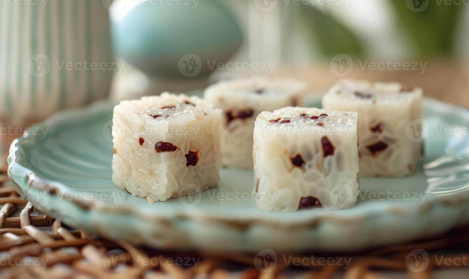 Chinese sweet rice cakes with red bean on a pastel green plate photo
