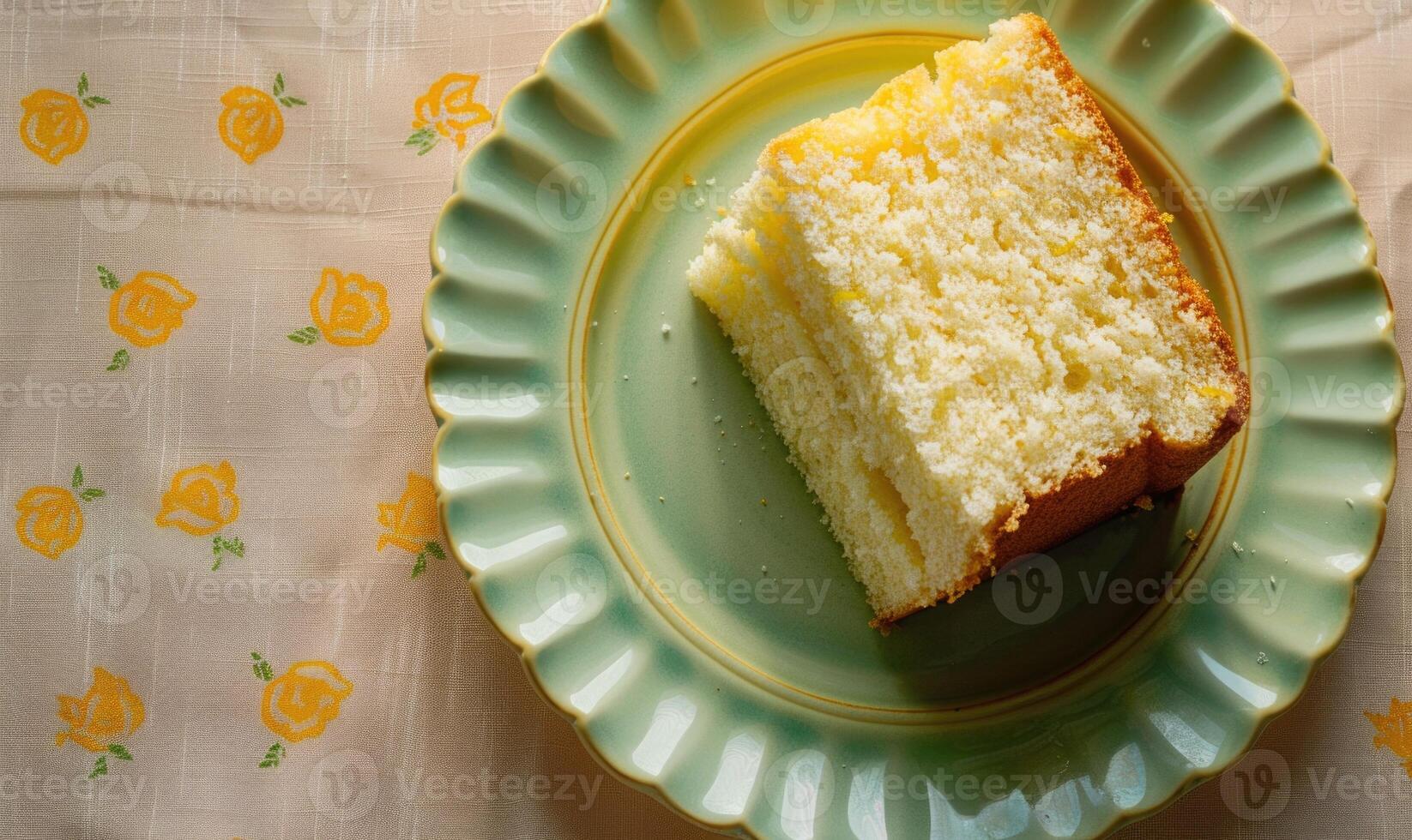 Lemon chiffon cake with lemon zest and a flat white on a pastel green plate photo