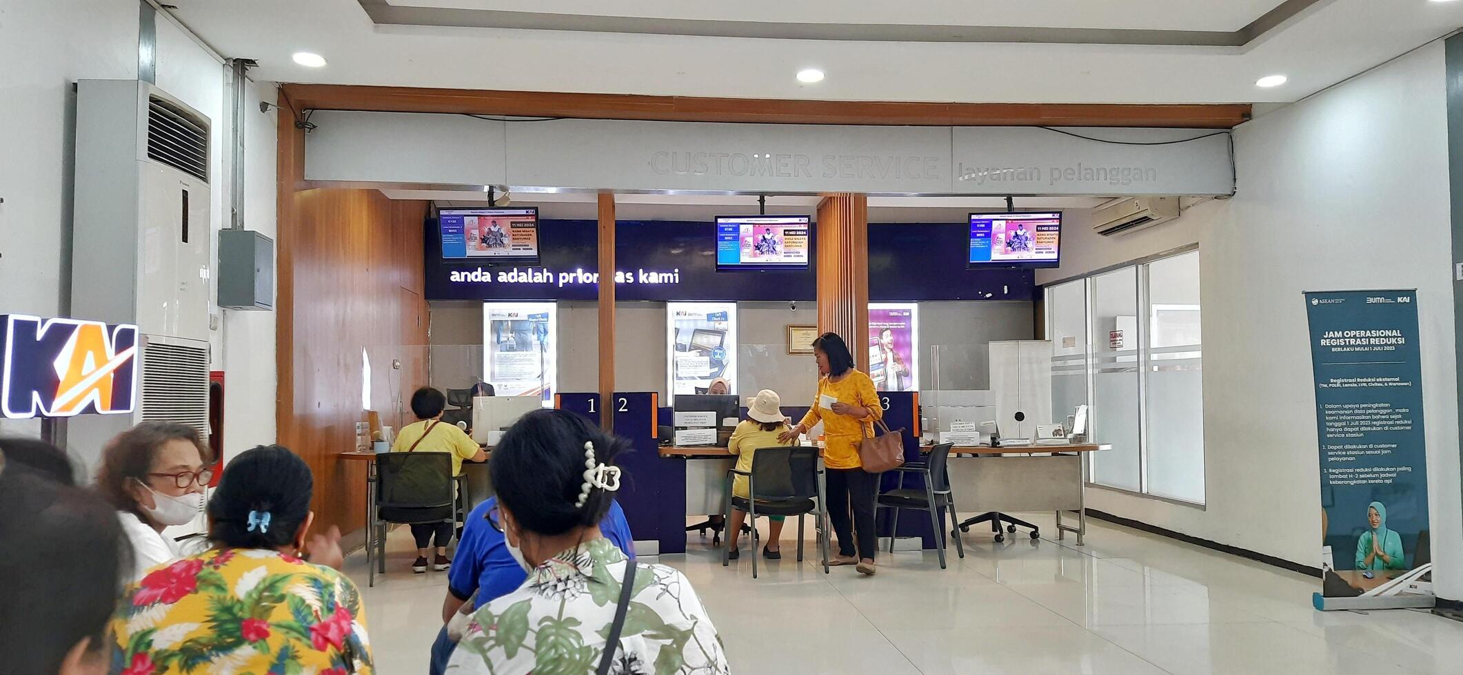 View of the Pasar Senen train station area. Local train and passengers activity. Jakarta, Indonesia - June 8, 2024 photo