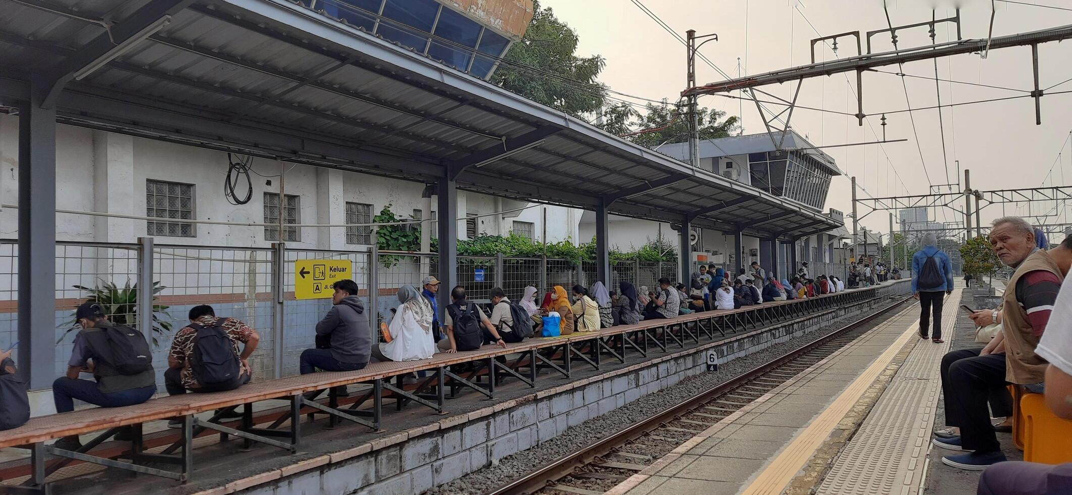 Atmosphere at railway train station. Local train activity in Indonesia. Railway road. Jakarta, Indonesia - Mei 28 2024 photo