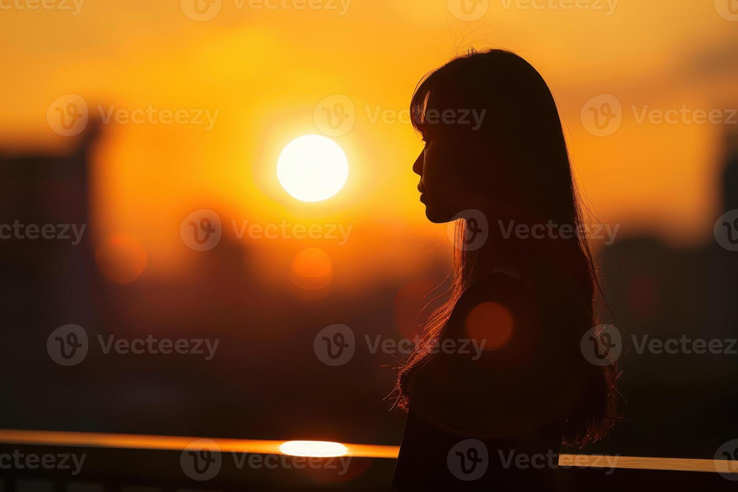silhouette of woman looking at the sunset photo
