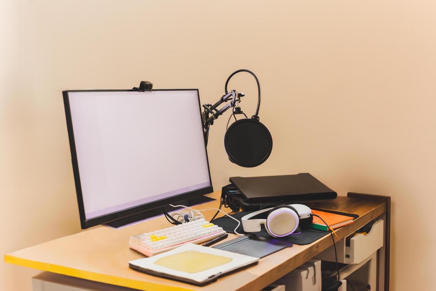Workplace at home with pc, microphone and headphones. Computer on table. photo
