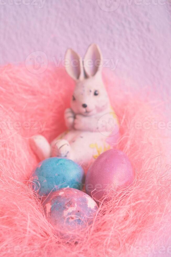 Space galactic Easter eggs in a pink nest next to a rabbit photo