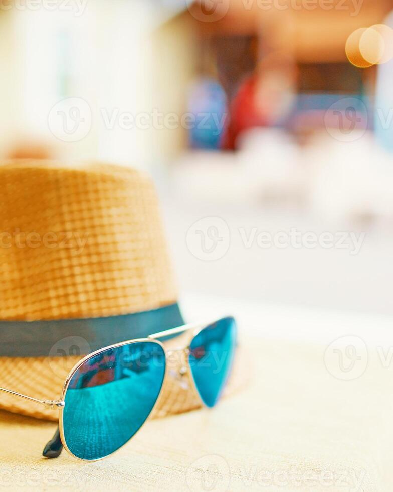 Straw hat on a hot day off with green sunglasses photo