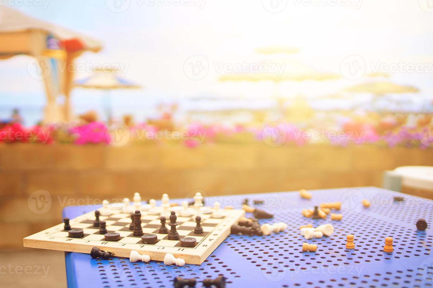 Scattered chess summer day on the table in the hotel on the beach photo