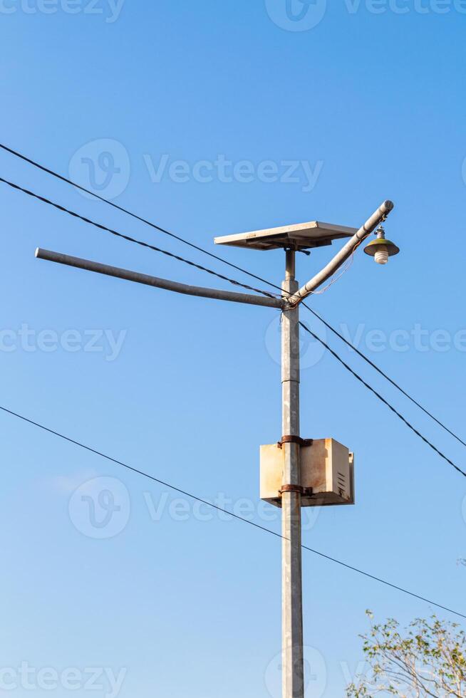 metal pole with common lights and cables with sky background photo
