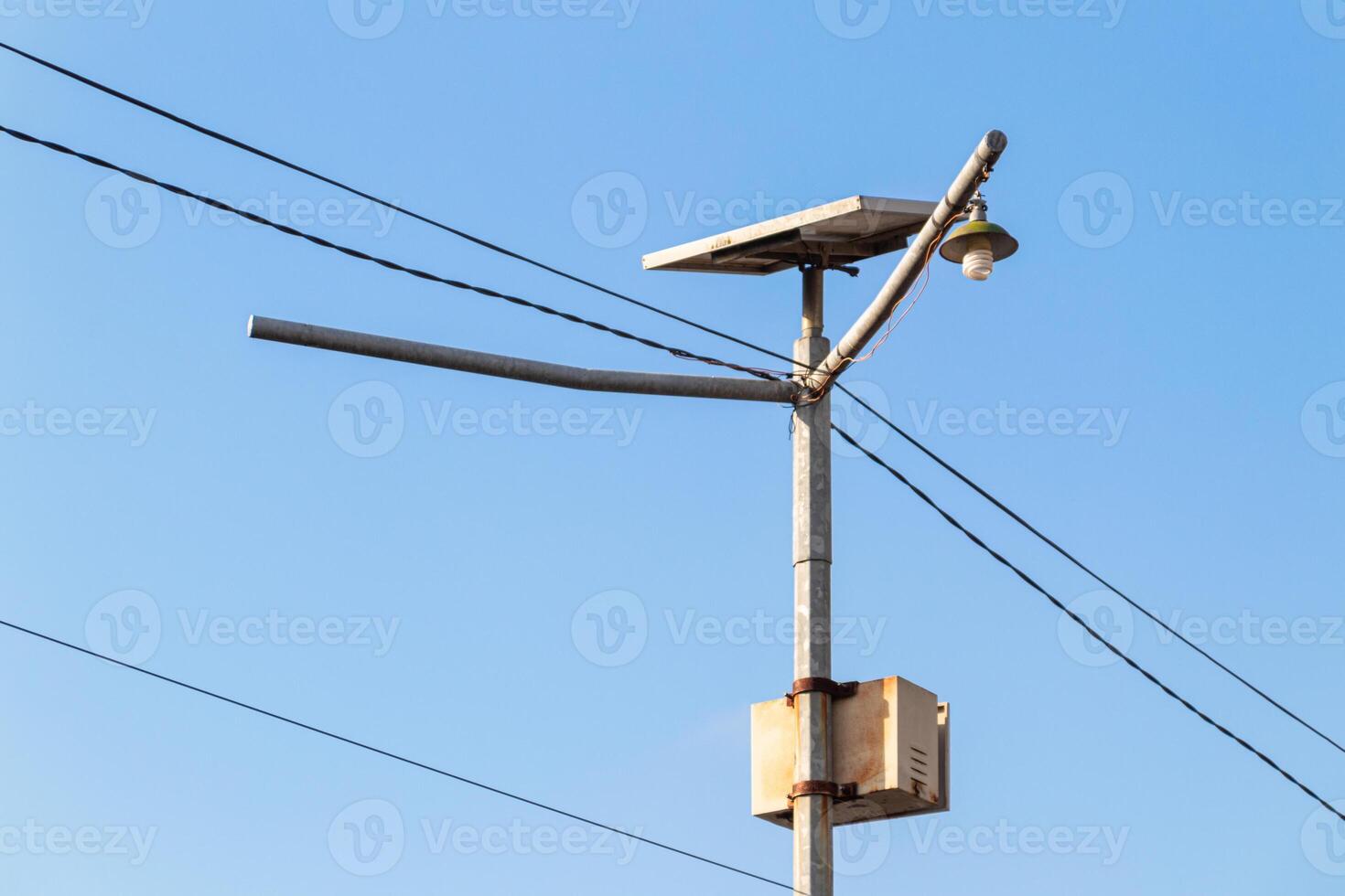 metal pole with common lights and cables with sky background photo