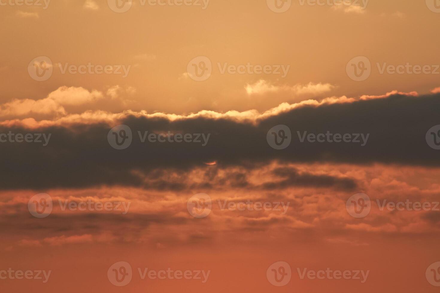 Close up view of sun hidden behind clouds photography photo