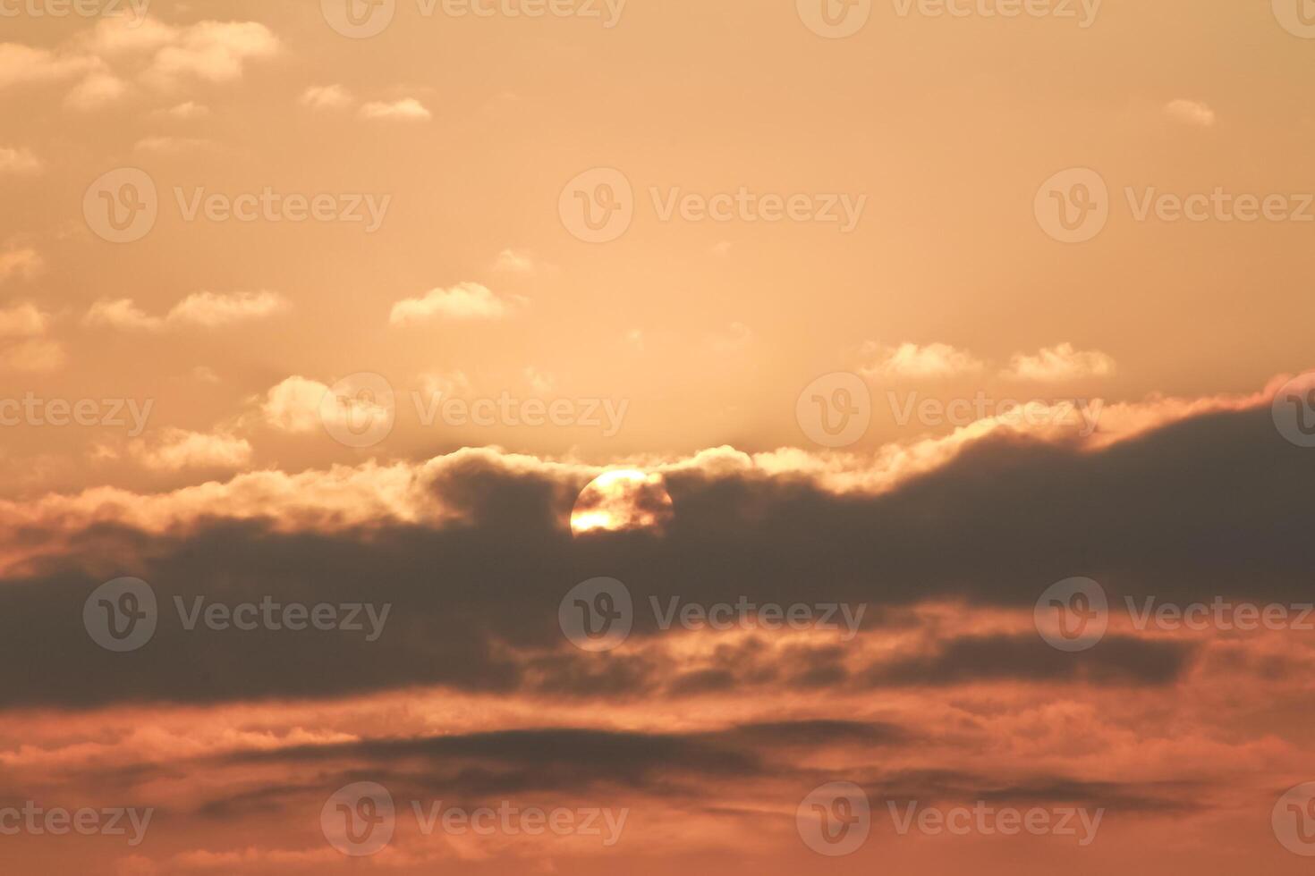 Close up view of sun hidden behind clouds photography photo