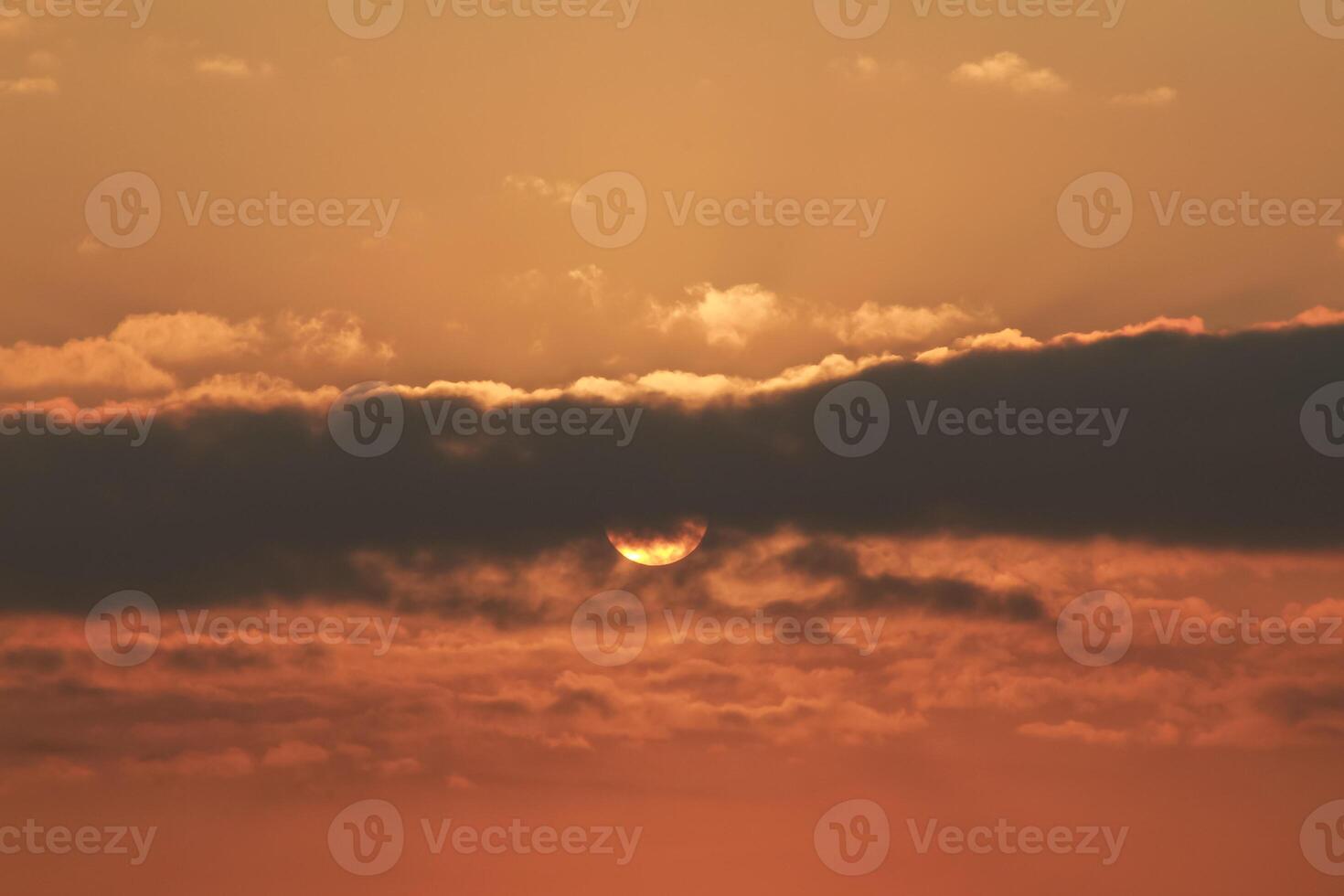 Close up view of sun hidden behind clouds photography photo