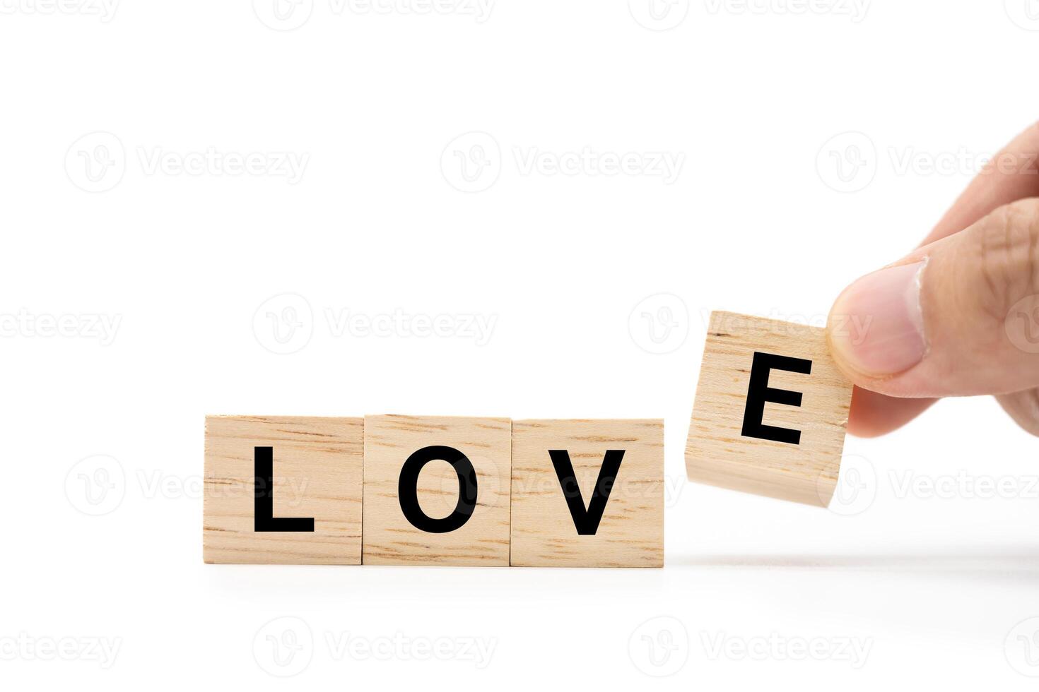 Hand place wooden blocks with LOVE text isolated on white background. Love symbol with copy space and clipping path. photo