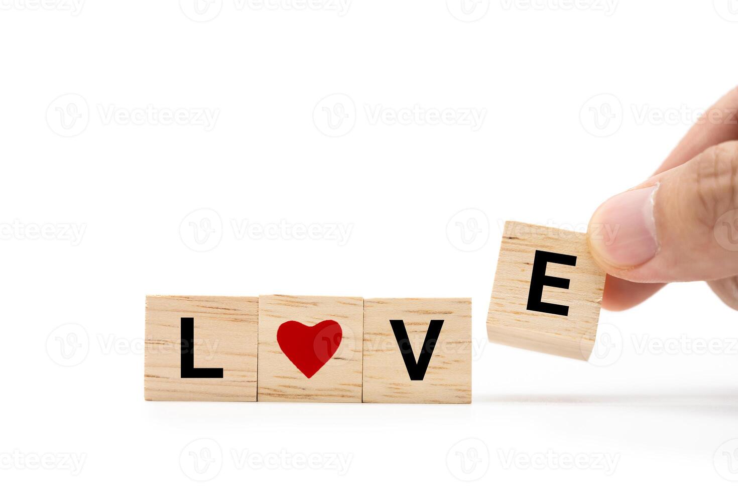 Hand place wooden blocks with LOVE text isolated on white background. Love symbol with copy space and clipping path. photo