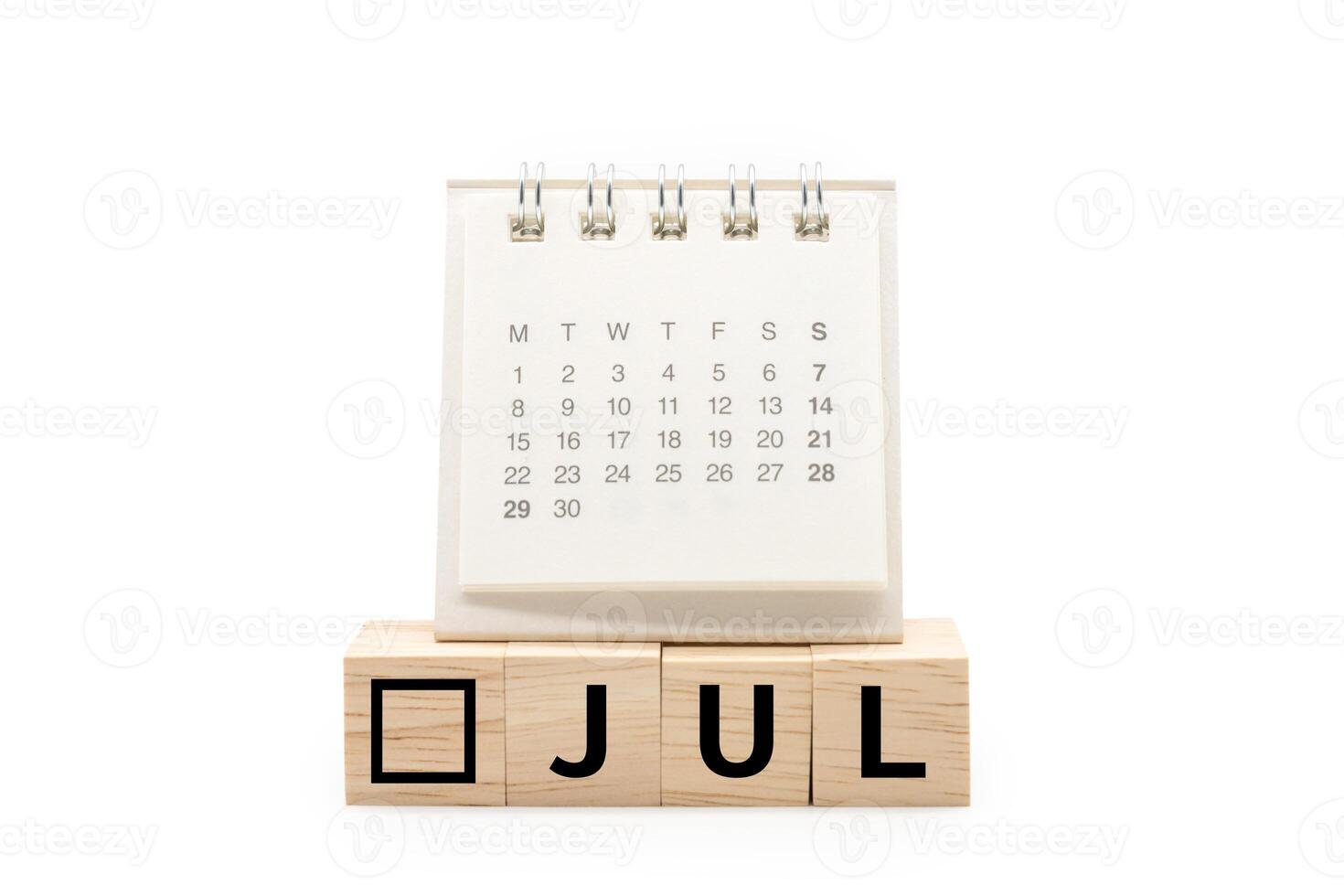 Calendar on Wooden blocks with JUL text isolated on white background. JULY and Calendar concept. Copy space. photo