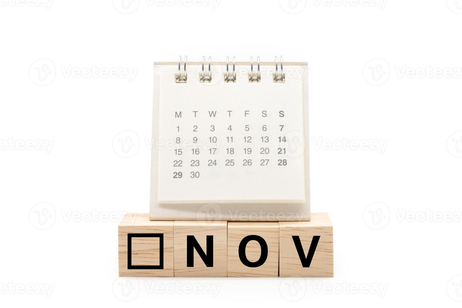 Calendar on Wooden blocks with NOV text isolated on white background. November and Calendar concept. Copy space. photo