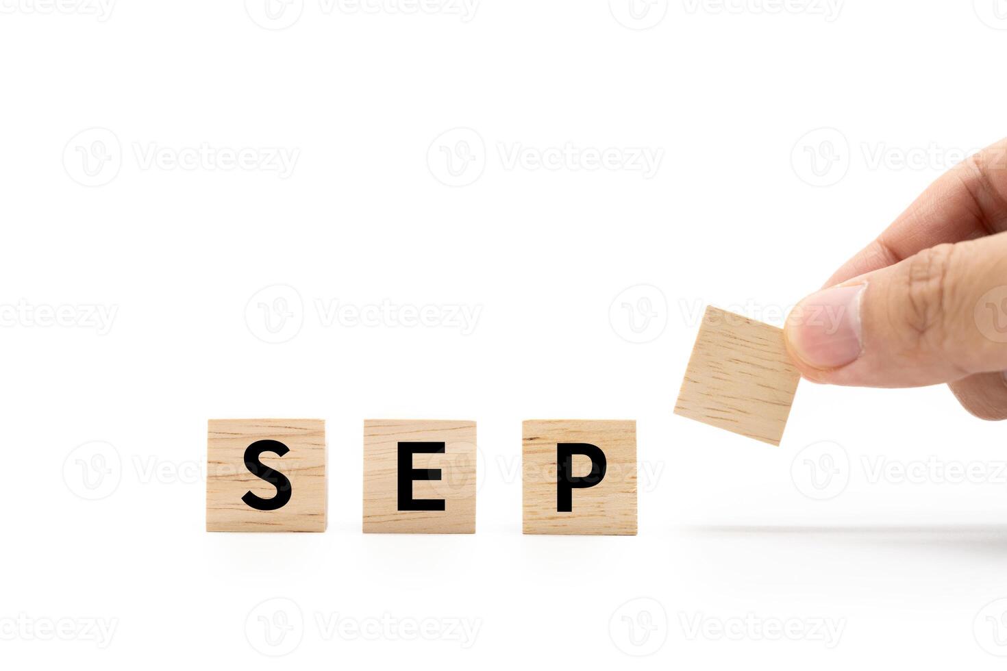 Hand place wooden blocks with SEP text isolated on white background. September and Calendar concept. Copy space. photo